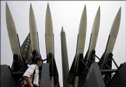 A tourist walks by displays of models of North Korea's Scud-B missile, center, and other missiles at the Korean War Memorial Museum in Seoul, South Korea. Opponents of a possible North Korean long-range missile test on Monday stepped up a diplomatic drive to stop the launch, issuing a barrage of warnings to the reclusive nation and threatening retaliation if it goes ahead.