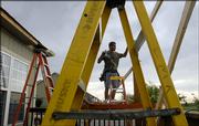 Anthony Klebenstein, of LMK Construction Inc., works on constructing a back deck to a Eudora home. Eudora's more affordable housing may be having an effect on Lawrence's population growth.