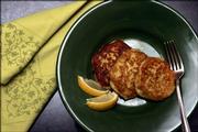 A serving of Bulgarian Leek Patties is shown with a lemon garnish. These patties include ground beef among their ingredients, but the patties also can be made without meat.