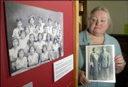 Helen Krische, archivist at Watkins Community Museum, has created a panel of historic photos and papers from her research into Lawrence's Hispanic community. The exhibit will be on display at St. John's Mexican Fiesta. At left is a photo of a children's dance troupe, and at right Krische holds a portrait of Maria and Jesse Ramirez, who settled in Lawrence.