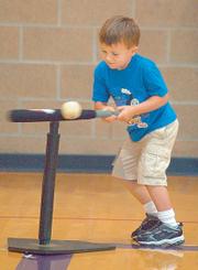Louden Schwab hits the ball during a game of Blastball on June 19 at the East Lawrence Center. In Blastball one player hits the ball and runs to jump on a single base while other players try to catch the ball.