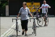 T-Mobile employees carry bicycles outside the team hotel in Blaesheim, France. Tour de France favorites including T-Mobile rider Jan Ullrich were barred Friday from riding in this year's race because of a doping scandal, causing a massive upheaval on the eve of cycling's premier event.