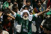 A Palestinian supporter of the Islamic group Hamas marches Friday with others during a rally supporting the group in the Jebaliya Refugee Camp. Palestinian Authority Prime Minister Ismail Haniyeh said Friday that Israel's offensive in Gaza was part of a premeditated plan to bring down the Hamas-led government, but Palestinian leaders were working to end the standoff.