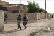 U.S. Army soldiers from the 1st Battalion, 502nd Infantry Regiment conduct a routine patrol in May in Mahmoudiyah, Iraq. The U.S. Army will investigate charges that five American soldiers from the unit were involved in the killings of four Iraqi relatives, including a woman who had been raped, military officials said Friday.