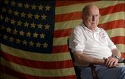 Lawrence resident Bob Evans, 85, is pictured before an 1876 38-star American flag handed down to him from his grandfather, Henry Sylvanus Rockey, who was a Union soldier with the Ohio Volunteers during the Civil War.