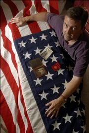 John Van Sickel, of Lawrence, has an American flag passed down from when his grandfather was killed in World War I.