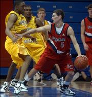 KC Pump-N-Run's Tyrel Reed handles the ball during an AAU basketball game against the Minnesota Magic. Reed, a senior-to-be at Burlington High, is considering attending Kansas University in the fall of 2007.