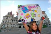 Mariah Richard, 11, of Watervliet, N.Y., whose parents are gay, holds up a sign during a rally in support of same sex marriage in Albany, N.Y. New York's highest court ruled Thursday that gay marriage is not allowed under state law, rejecting arguments by same-sex couples who said the law violates their constitutional rights.