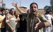 An Iraqi man on Monday mourns the loss of his two brothers killed in Sunday's double car bomb attack in Baghdad, Iraq. Two car bombs exploded Sunday evening near a Shiite mosque in the city's north, killing 17 people and wounding 38 in what appeared to be a reprisal attack, police said.