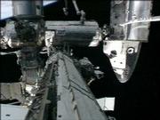 the space shuttle Discovery's nose and the International Space Station can be seen during the second spacewalk Monday in this image made from NASA TV.