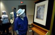 Lawrence resident Frank Shontz grabs a closer look at a painting titled "The Founding of Chicago" by Aaron Douglas, a black artist and native Kansan, shortly after the painting was unveiled Friday at the Spencer Museum of Art at Kansas University.