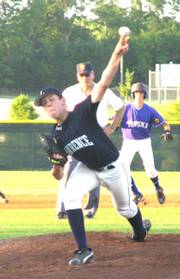 Lawrence Maverick Tom Schuh throws a pitch as an umpire watches. The Mavericks played host to a tournament at Free State High School from July 11-16.