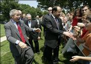 President Bush, left, and Iraqi Prime Minister Nouri al-Maliki, center, greet family members of military personnel during a visit to Fort Belvoir, Va. The two leaders had lunch with soldiers there on Wednesday after al-Maliki gave an address to Congress.