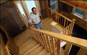 John Craft, owner of Kaw Valley Home Care, stops along the stairway of one of his recently built homes at 1417 Prospect Ave. Craft believes that the home is the most energy efficient in the area, primarily because of its use of concrete walls and floors, which keep the interior at a near constant temperature.