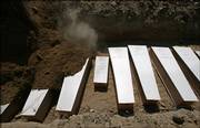 The smallest of the 31 simple plywood coffins, center, containing 1-day-old girl Sawsan Tajeldin, can be seen as a bulldozer pours soil to bury Lebanese victims Saturday in a mass grave at the southern port city of Tyre, Lebanon. Sawsan was killed along with her mother when the car in which they were fleeing was hit by an Israeli warplane missile strike.