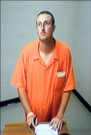 Alex Wood appears in a video feed from the Sedgwick County Jail displayed on a monitor before District Court Judge Joe Kisner as Kisner reads the charges against him Thursday in Wichita. Wood and his wife, Jennifer Wood, face two counts each of felony child abuse. Jennifer Wood also is charged with one count of aggravated battery. Both adults were jailed Thursday on $100,000 bond.