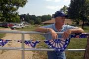 John Welborn stands at the front gate of his rural Jefferson County home, which has been burglarized 13 times since the late 1970s. Prosecutors say his home was the first to be burglarized in a four-county 2005 crime spree that included the killing of Clarence David Boose, 77, of rural Lecompton. Welborn says he has yet to see any restitution ordered for previous burglaries, and doesn't expect any for the latest incident.