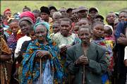 Voters wait outside a polling station in Dele, Congo. Voting began Sunday in Congo's first democratic election in more than 40 years, a colossal exercise that many hope will bring an end to years of fighting and corrupt rule that have devastated this gigantic, mineral-rich nation in the heart of Africa.