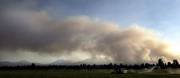 The Black Crater Fire near Sisters, Ore., sends up a huge plume of smoke. Two communities near the fire remained evacuated Monday.
