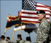 Maj. Gen. Carter Ham watches soldiers march past during a change of command ceremony at Fort Riley. Tuesday's ceremony marked the return of the 1st Infantry Division headquarters to Kansas after 10 years in Germany.