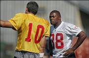 Chiefs running back Michael Bennett, right, listens to quarterback Trent Green. Bennett practiced with the Chiefs for the first time Thursday afternoon in River Falls, Wis.