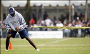 Terrell Owens stretches during practice at Cowboys training camp. Owens sat out of practice Thursday in Oxnard, Calif., because of a sore hamstring.