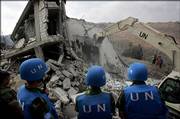 Chinese U.N. soldiers watch as equipment is used to dig for bodies under the rubble of a home that was hit in an Israeli missile strike Monday. Human Rights Watch and news organizations reported that 54 or more civilians died in the airstrike, but a re-examination Thursday indicated 28 deaths.