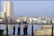 Cuban police officers patrol the Malecon, an oceanfront boardwalk in Havana, Cuba. Cuba's communist leadership launched a campaign Friday emphasizing the revolutionary roots of Fidel Castro's brother and designated successor, attempting to reassure Cubans that the regime remains stable after Fidel Castro's hospitalization.