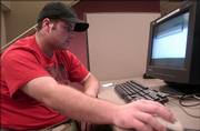 Joe Dodge works on a computer at the Lawrence Public Library, 707 Vt. Dodge said he used the Internet mostly for checking message boards, e-mails and his MySpace page.