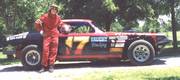 Max Roberts leans against one of his first cars before a race at Thunderhill Speedway in Mayetta, Ks.