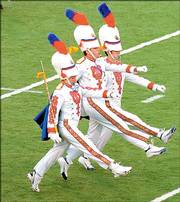 Kansas University Drum Corps Majors lead the band onto the field at Memorial Stadium for a Sept. 17, 2005, game. David Clemmer has been announced as the new director of athletic bands and assistant band director.