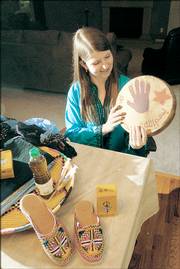 Stacy Sabraw recently returned from her Peace Corps assignment in Morocco and brought back a lot of memorabilia. She says the drum she's holding reminds her of the friends she made during her visit.