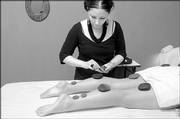 Danielle Meyeres gives a client hot stone therapy at Salon Di Marco & Day Spa, 733 Mass. The massage treatment is among many services the salon provides for customers looking for nontraditional means of therapy and relaxation.
