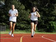 Katelyn Choiniere, 15, and her mother, Donna, 52, do a warm-up lap in Albany, N.Y. In an effort to be healthy, the family doesn't diet but makes exercise a part of life.