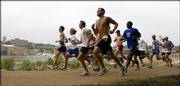 Runners embark on a four-mile course on the Kansas River levee for the second annual Red Dog Run. About 240 runners participated in the event, which was organized by the Lawrence Boys & Girls Club and Don "Red Dog" Gardner on Saturday and raised $24,000 for the Boys & Girls Club's programs.