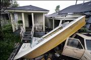 A boat rests partially on a car July 24 in the Lower Ninth Ward of New Orleans, where much cleanup remains to be done after the neighborhood was flooded by Hurricane Katrina.
