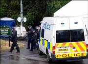 British police leave their temporary headquarters on the edge of King's Wood in High Wycombe, England, about 35 miles west of London. London's anti-terrorist police pressed ahead with a major search in the woodland area on Monday. The search will continue through today, though officers declined to say whether anything significant had been discovered.