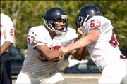 Lawrence High's Shawn Jimboy, left, and Cory Roberson lock up during a drill. The Lions broke out their pads for the first time Thursday and immediately started hitting.