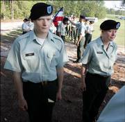 Pfc. Kimberly Brown, 37, right, and her 18-year-old son Pfc. Derek Noe, left, of Boone, N.C., prepare to graduate together during a ceremony Friday at the Army's training facility at Fort Jackson in Columbia, S.C.