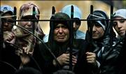Lebanese women react as they watch from outside a cemetery as 55 Hezbollah fighters, who were killed in fighting with Israeli forces in southern Lebanon, are buried Saturday in the southern suburbs of Beirut.