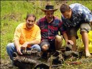 A Tonganoxie man, Garry Bichelmeyer, left, and three relatives found on the Wakarusa River what Kansas University researchers believe are pieces of an American mastodon, which roamed the area 10,000 to 20,000 years ago. In the photo above, which was taken by Mike Billups of Shawnee, Garry Bichelmeyer is shown with Mark Bichelmeyer and Kyler Mogusar and their fossilized mastodon jaw. Garry Bichelmeyer discovered the fossil last week while the four were on a kayak trip.