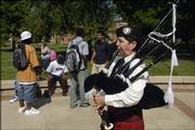 Dorothy May, a member of St. Andrew Pipes and Drums, plays on the first day of classes at Baker University. Baker, which had about 928 students on the first day, began the fall semester on Wednesday with a new school president at the helm.