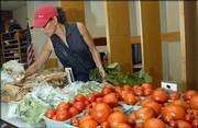 Randi Hacker, a member of the Rolling Prairie Farmers Alliance, shops recently at the Lawrence Senior Center, one of the pickup sites for those who subscribe to the service for fresh, locally grown produce.