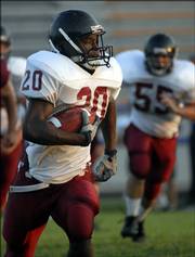 Lawrence High's Tony Williams breaks into the open. LHS held its fall sports showcase Wednesday at Haskell Stadium.