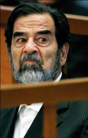 Saddam Hussein, the former Iraqi leader, looks across the court Wednesday during day three of the Anfal Campaign trial in Baghdad.