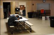 A patron rests his head as he waits for the Friday noon meal at The Salvation Army, 946 N.H. The agency and several others that serve people in need are running low on food supplies and are asking for donations from the community.