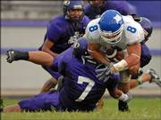 Peru State's Derek Darr (8) is brought down by Haskell Indian Nations University's Mario Torres during the first half of their showdown at Haskell Stadium.