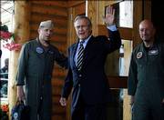 Defense Secretary Donald H. Rumsfeld waves Saturday as he leaves for Fort Wainwright in Fairbanks, Alaska, where he met privately with 172nd Stryker Brigade families, the unit's home base. Rumsfeld plans to meet with Russian Defense Minister Sergei Ivanov today.