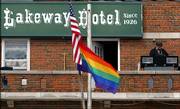 J.R. Knight plays music, including "Somewhere Over the Rainbow," from the balcony of the Lakeway Hotel in Meade on Sunday as members of the Topeka-based anti-gay Westboro Baptist Church picket across the street. The church group was in town because the hotel has been flying a rainbow flag, a gift from the 12-year-old son of the owners.