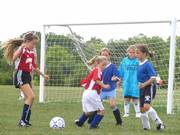 The U9 Kaw Valley Soccer Assn. Pink Panthers try to defend their goal as Angels players challenge it. The Pink Panthers and Angels played each other on Saturday at Youth Sports Inc.